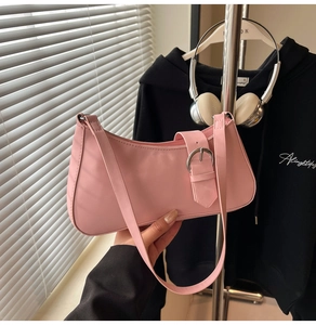 Detailed view of pink matte PU leather baguette bag with silver buckle and shoulder strap