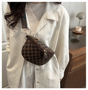 Detail view of vintage checkered crossbody bag with patterned wide strap and canvas texture