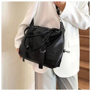 Close-up of a large capacity black vintage tote bag with adjustable shoulder strap