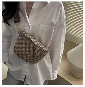 Macro detail of retro jacquard waist bag with M-pattern and woven strap accents