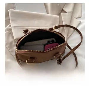 Top view of brown retro shell bag showing spacious interior for phone and wallet