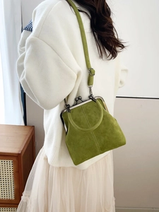 Close-up of grass green vintage doctor bag with metal frame clasp and adjustable strap