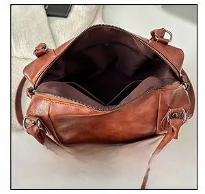 Top view of brown retro handbag showing spacious interior with zipper pocket and lining