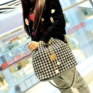Chic houndstooth bucket bag with drawstring closure and elegant pearl charm detail