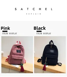 Detail view of pink and black corduroy backpacks with star and tassel zipper charms