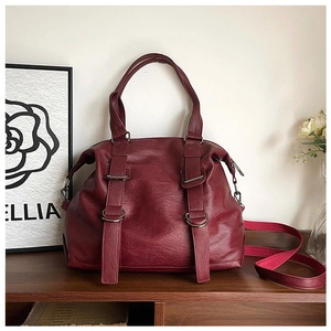Detail of burgundy PU leather tote showing pebble texture and detachable shoulder strap