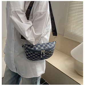 Detail of blue crescent bag with letter print and adjustable jacquard strap
