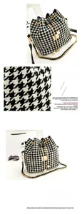 Detail of houndstooth bucket bag featuring gold chain strap and elegant pearl charm