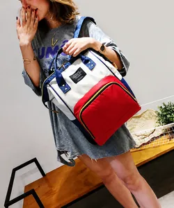 Three-color patchwork Oxford backpack with spacious front pocket and top handle