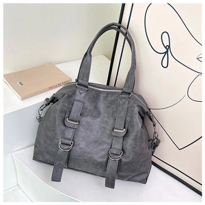 Close-up of vintage dark grey large tote bag with matte leather texture and silver hardware