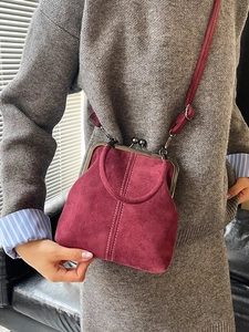 Vintage burgundy suede crossbody bag with metal frame clasp and adjustable strap