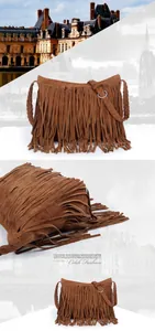 Close-up of brown suede fringed bag featuring woven straps and metal ring accents