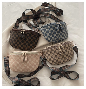 Flat lay of vintage monogram fanny packs in four colors with adjustable patterned straps