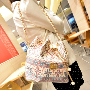 Ethnic style bucket bag with geometric prints, drawstring closure, and pearl chain strap