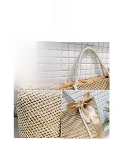 Detailed close-up of woven straw handbag handle with silk champagne bow decoration