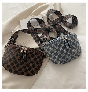 Detail view of vintage jacquard crescent bags with ethnic style straps and golden zippers