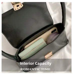 Detail view of black faux leather bag interior showing space for phone and makeup