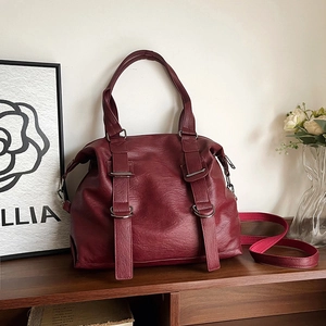 Vintage burgundy faux leather tote bag with pebble texture and metallic buckle details