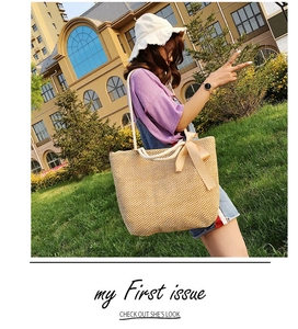 Straw tote bag detail with cream silk bow and white rope handle for summer style