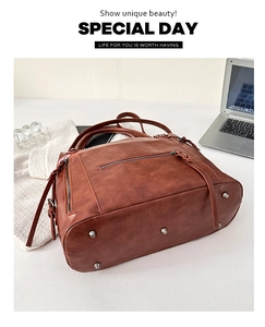 Detail view of brown vintage leather tote bag showing protective bottom metal studs