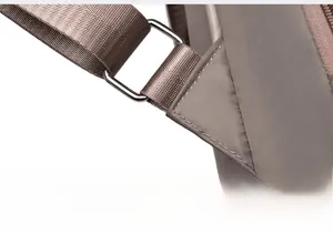 Close-up of reinforced shoulder strap stitching and metal ring on oxford backpack