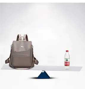 Detailed view showing the lightweight 0.5kg backpack balanced against a water bottle