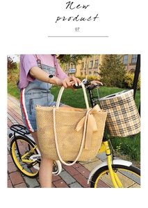 Macro detail of hand-woven straw tote bag with rope handle and decorative silk bow