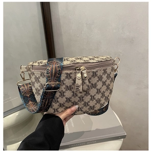 Detail of jacquard small handbag with retro pattern strap and double metal zippers