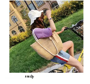 Outdoor lifestyle shot of a beige woven tote bag with rope handles on a yellow bicycle