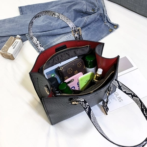 Black crocodile texture tote bag with snake skin handles and red lining interior space