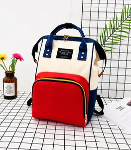 Close-up of three-color oxford canvas backpack with golden zipper and logo patch