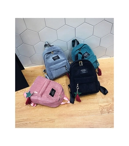 Top view of mini corduroy backpacks in four colors with star and tassel charms