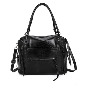 Minimalist black faux leather motorcycle tote bag with dual handles and long tassel zippers