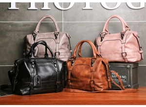 Detail view of four Boston style PU leather handbags in black, brown, pink, and grey