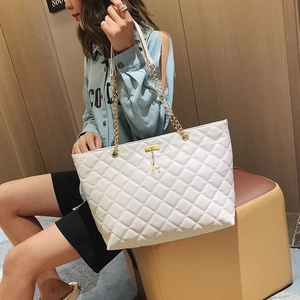 White quilted tote bag with chain strap and gold deer charm for casual women's fashion