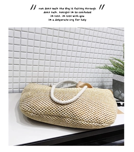 Detailed texture of hand-woven straw bag with thick white rope handles and fabric lining