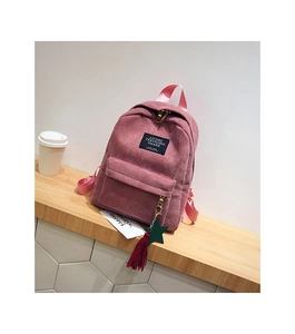 Pink corduroy backpack featuring a front zipper pocket and decorative tassel pendant