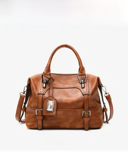 Front view of brown leather Boston handbag with double handles and metal hardware detail