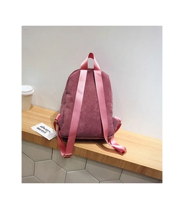 Close-up of pink corduroy backpack featuring vertical stripes and high-density straps
