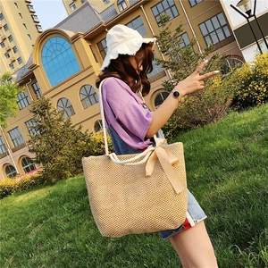 Handwoven straw beach bag with champagne ribbon bow and thick rope shoulder straps