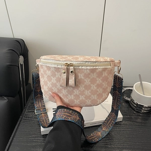 Pink crossbody bag with M-pattern print and bohemian style wide woven shoulder strap