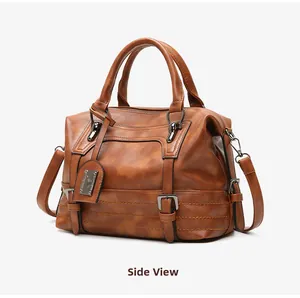 Side view of vintage brown leather Boston bag showing metal hardware and side straps