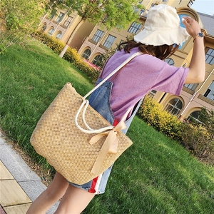 Handwoven straw tote bag with a chic bow and cotton rope handles for summer beach vacations