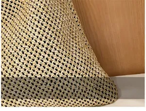 Detailed close-up of natural woven straw texture on a handmade beach handbag
