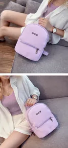 Model toont een lavendelpaarse kleine PU-lederen rugzak voor kinderen en dames