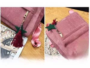 Detailed macro view of pink corduroy backpack with green star tassel and logo label