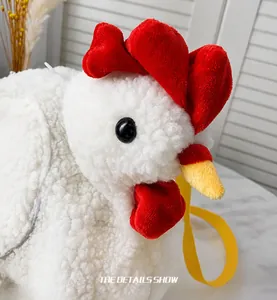 Close-up of cute plush chicken bag featuring white fleece texture and red comb detail
