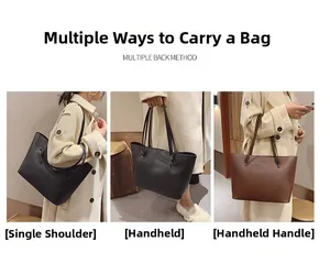 Sac fourre-tout en cuir noir et marron porté à l'épaule, à la main et au bras