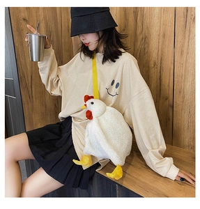 Detail of cute white plush chicken crossbody bag worn by a model in casual setting