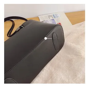 Détail d'un cabas en cuir noir avec coutures précises et boucle en métal foncé élégante